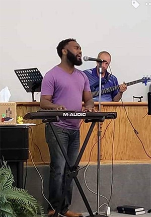 Man-Playing-Keyboard-Singing-At-Church-comp